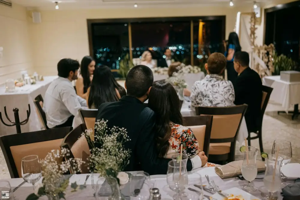 Wedding guests seated at decorated tables at night, illustrating guest relationships